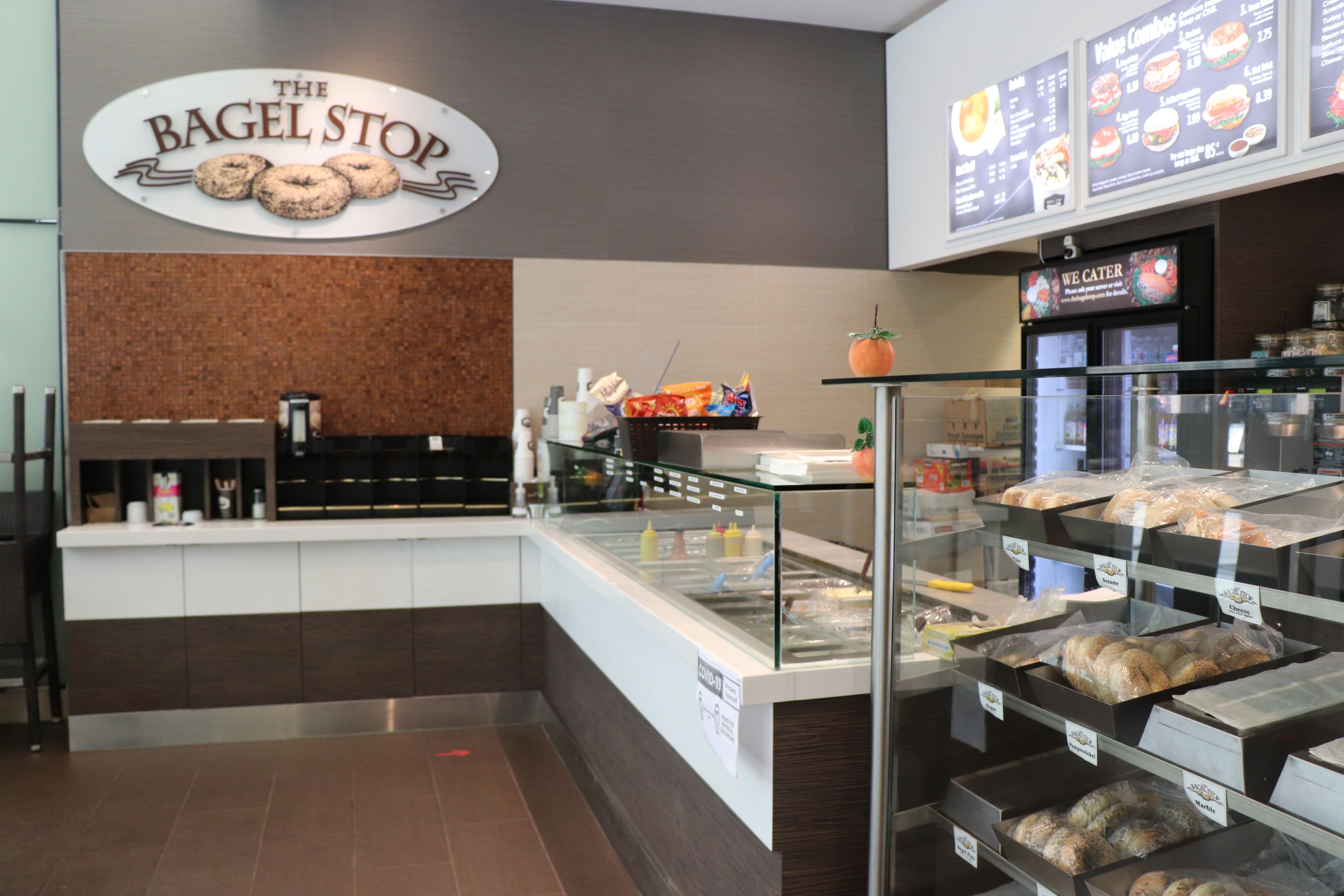 Bagel Stop glass counter, with bagels and coffee in view
