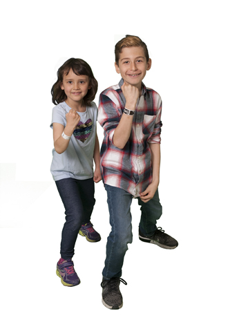 Two kids stand side by side showing new ID bands on their arms.