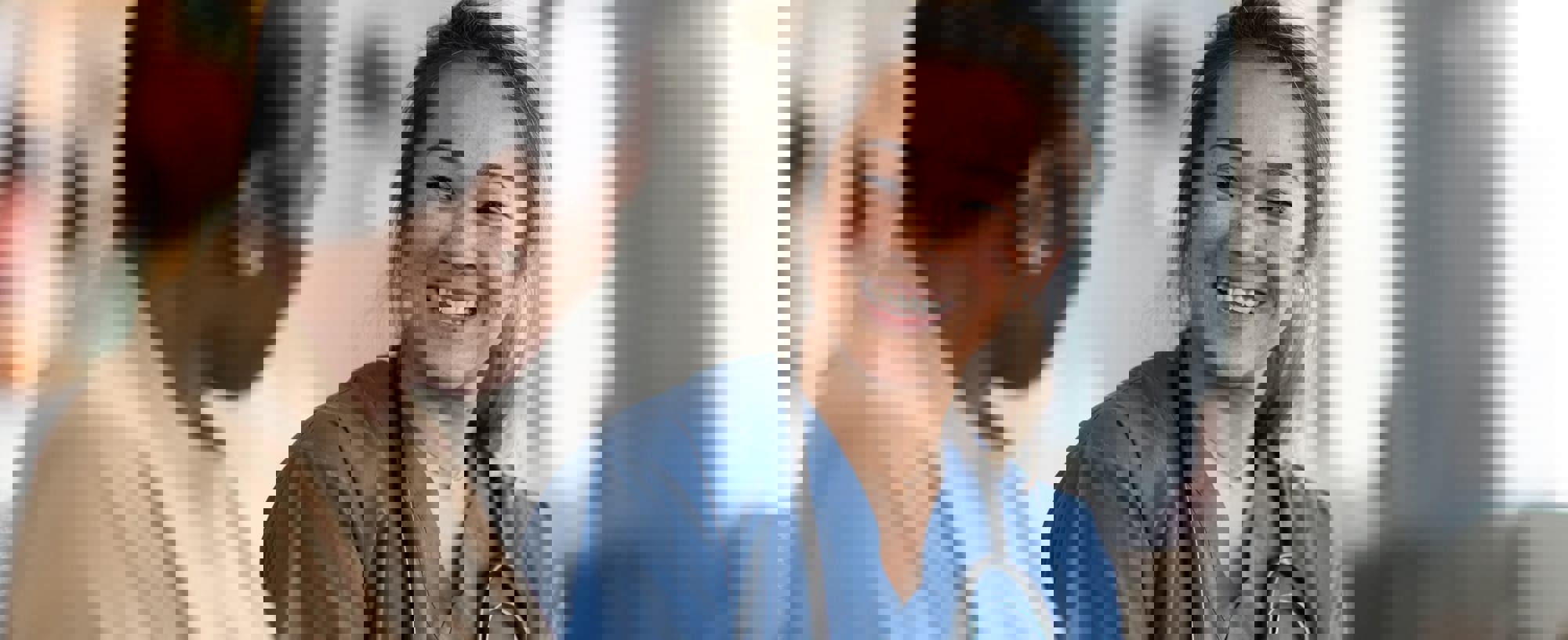 2 smiling medical colleagues in discussion