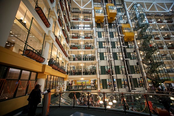 An interior view of the SickKids atrium. You can see people crowded along the walkways on many floors.