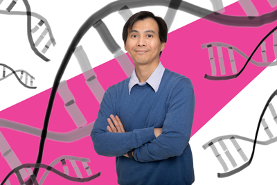 Dr. Toan Nguyen stands with his arms crossed infront of a pink background.