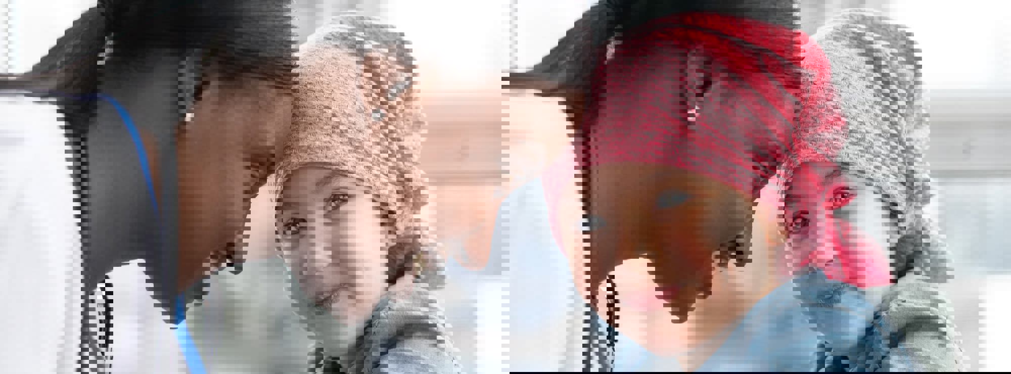 a young cancer patient smiling with their happy doctor