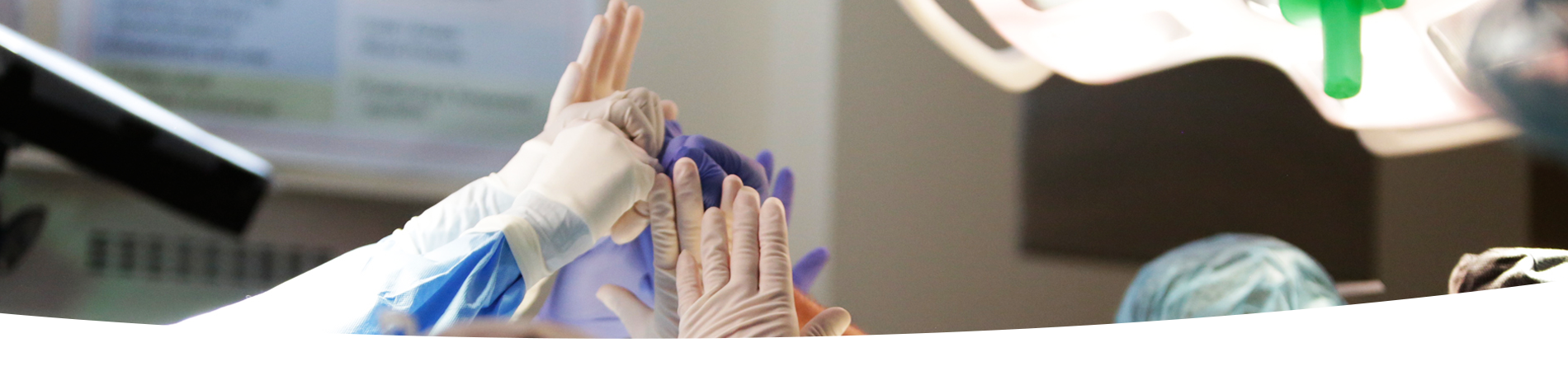 Close up of surgeon hands high fiving during operation