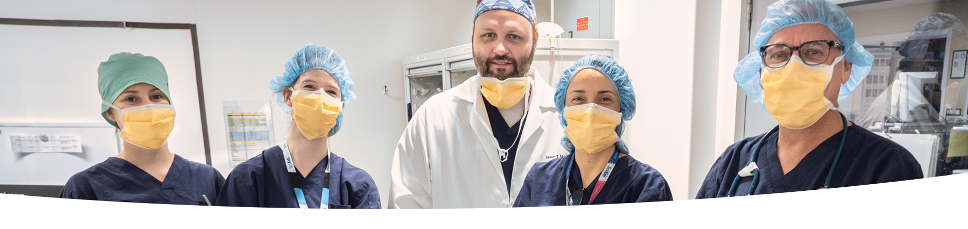 Surgeons standing wearing masks