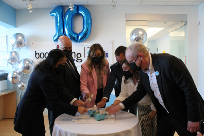 Dr. Madhavi Moharir, Honourable Steven Del Duca, Lara Pietrolungo, Jeff Mainland, Alexandra Ieraci, and Dr. Ronald Cohn in masks celebrating the 10 year anniversary of Boomerang Health.