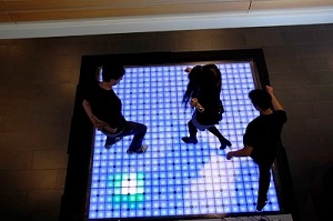 Children dance on a light up floor