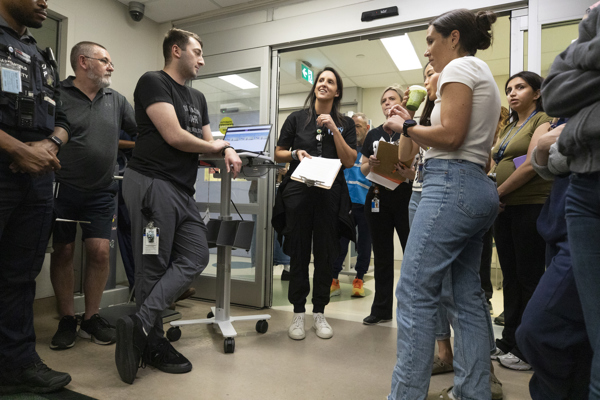 Dr. Natasha Collia, trauma education and simulation lead briefs team before the simulation.