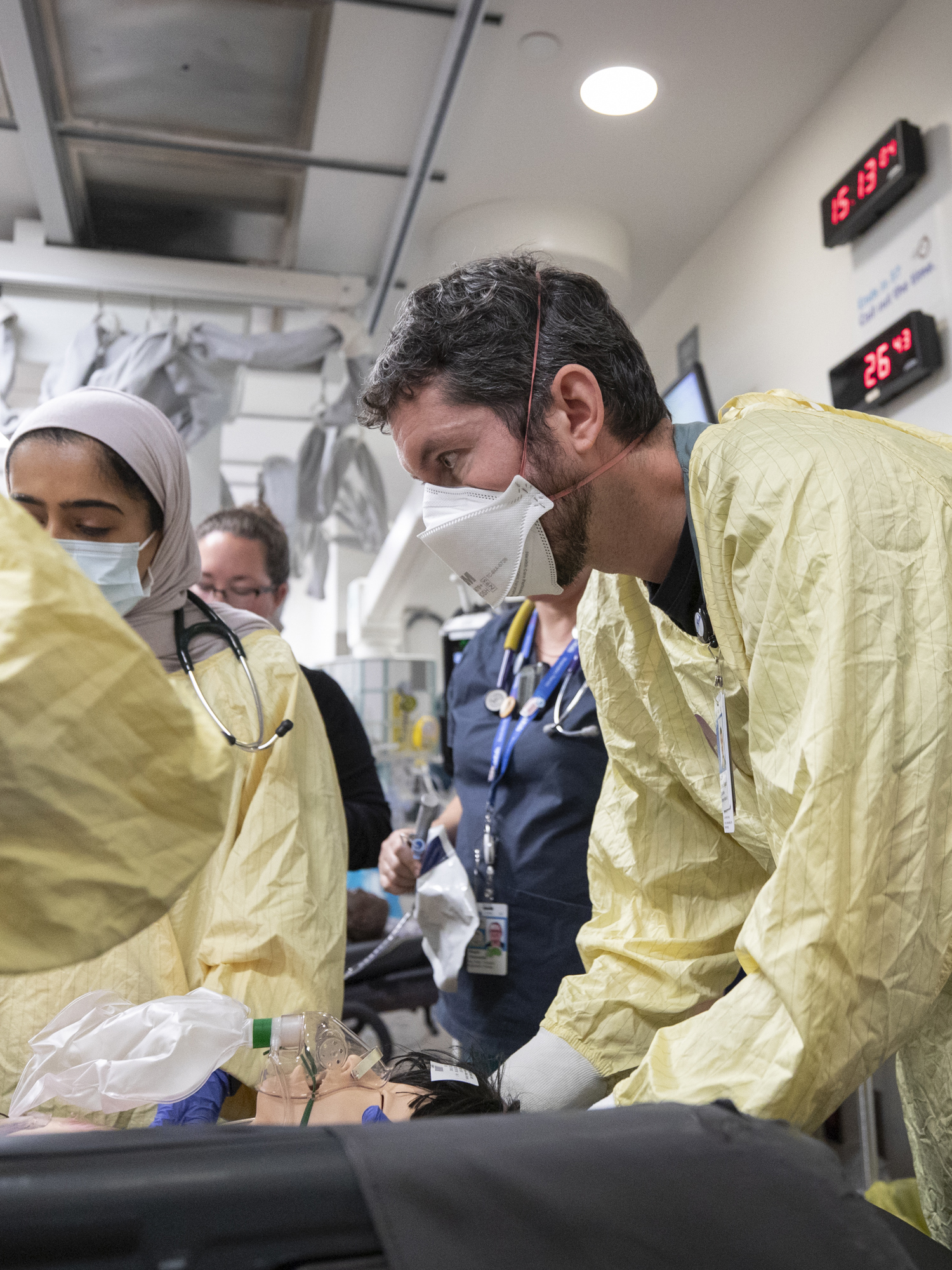 A care team member stabilizes a simulated patient in the trauma room.