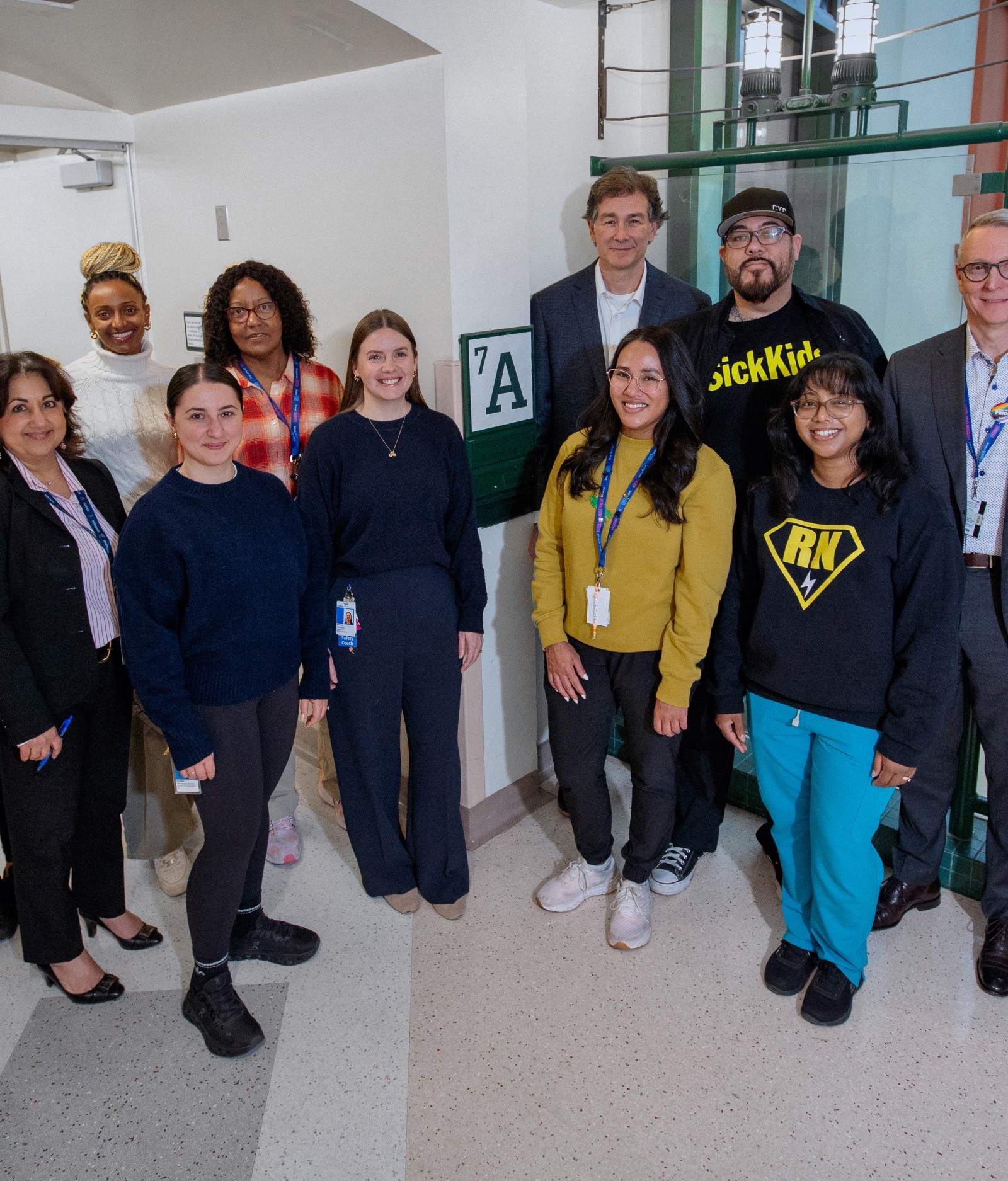 Members of SickKids' mental health leadership and front-line staff gather in the hospital in celebration of the Schedule 1 designation.