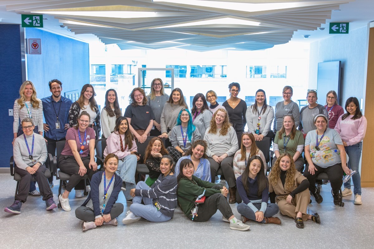 Around 30 members of the Child Life team pose for a group photo.